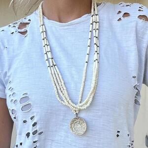 Wooden beaded necklace with a silver coin pendant